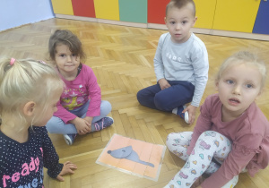 4 dzieci pokazuje ułożonego z elementów pieska.