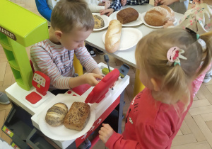 Przedszkolaki podczas zakupów wybranego przez siebie rodzaju chleba, w przedszkolnym sklepiku.