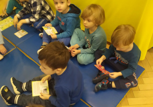 Przedszkolaki siedząc na materacu, zapoznają się z wybranymi prawami dziecka.