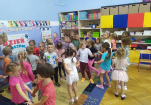 Dzieci wesoło tańczą przy muzyce pop.