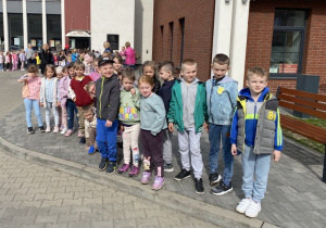 Wiewiórki pozują do zdjęcia na tle budynku Powiatowego Centrum Animacji Społecznej.
